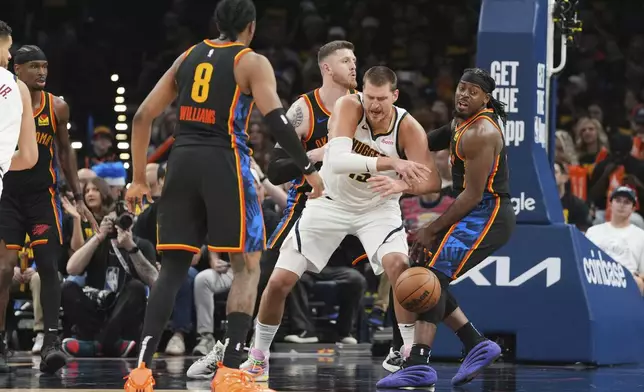 Denver Nuggets center Nikola Jokic, center, loses control of the ball as Oklahoma City Thunder's Jalen Williams (8), Isaiah Hartenstein, center rear, and Luguentz Dort, right, defend in the second half of Game 2 in the conference semifinals of the NBA basketball playoffs, Wednesday, May 7, 2025, in Oklahoma City. (AP Photo/Kyle Phillips)