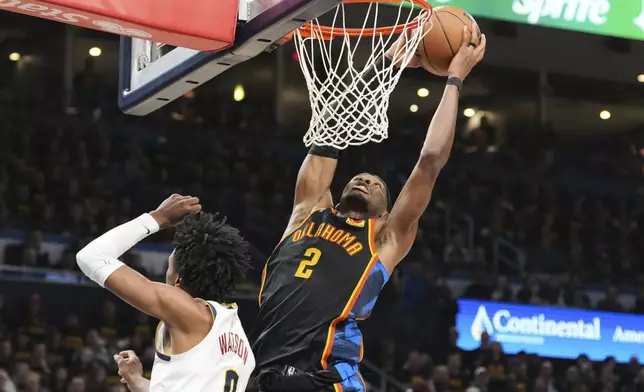 Oklahoma City Thunder guard Shai Gilgeous-Alexander (2) leaps to the basket for a shot over Denver Nuggets' Peyton Watson (8) in the second half of Game 2 in the conference semifinals of the NBA basketball playoffs, Wednesday, May 7, 2025, in Oklahoma City. (AP Photo/Kyle Phillips)