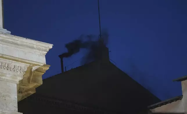 Black smoke billows from the chimney of the Sistine Chapel during the cardinals' conclave to elect a new pope, at the Vatican, Wednesday, May 7, 2025. (AP Photo/Alessandra Tarantino)