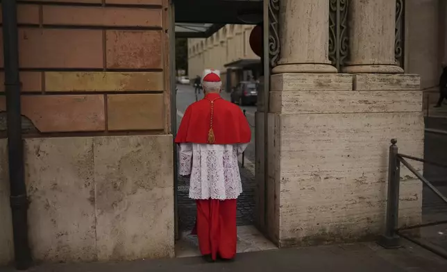 Cardinal Giuseppe Versaldi walks through the St. Anna gate, at the Vatican, Wednesday, May 7, 2025. (AP Photo/Francisco Seco)