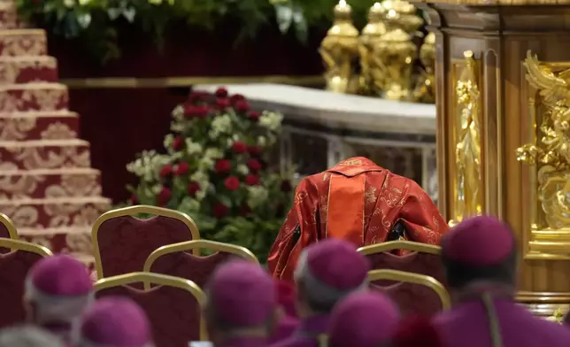 Cardinal Camillo Ruini is seen in the front row with his head hidden during a final Mass celebrated by cardinals inside St. Peter's Basilica before the conclave to elect a new pope, at the Vatican, Wednesday, May 7, 2025. (AP Photo/Gregorio Borgia)
