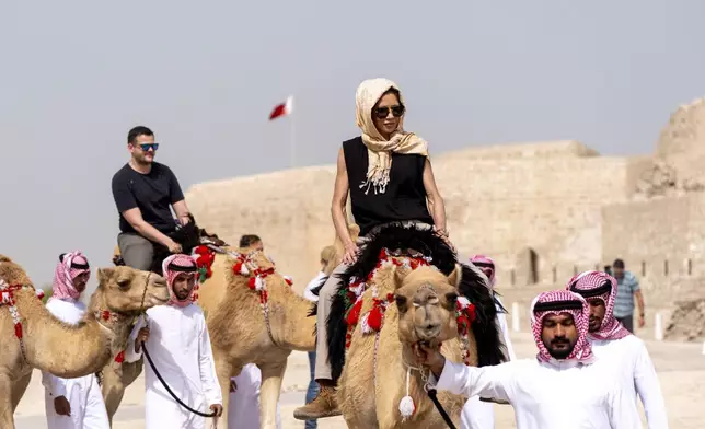 Homeland Security Secretary Kristi Noem rides a camel after a tour of Qal'at al-Bahrain Fort, Sunday, May 25, 2025, near Manama, Bahrain. (AP Photo/Alex Brandon, Pool)