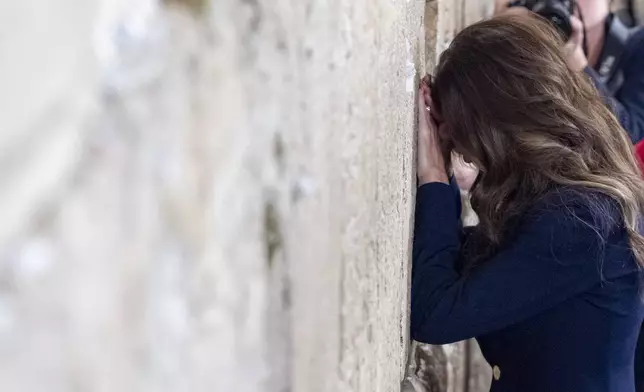Homeland Security Secretary Kristi Noem bows her head after placing a note at the at the Western Wall, the holiest site where Jews can pray, in the Old City of Jerusalem, Sunday, May 25, 2025. (AP Photo/Alex Brandon, Pool)