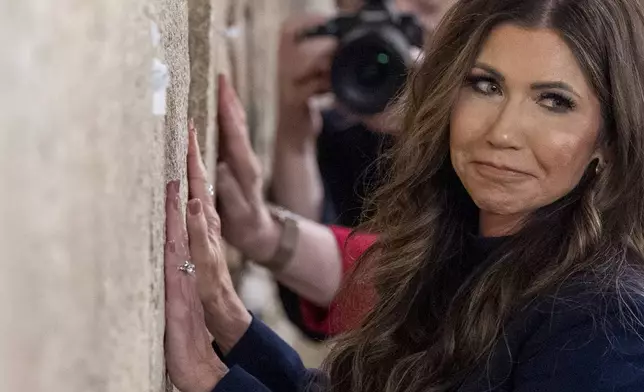 Homeland Security Secretary Kristi Noem pauses after placing a note at the at the Western Wall, the holiest site where Jews can pray, in the Old City of Jerusalem, Sunday, May 25, 2025. (AP Photo/Alex Brandon, Pool)