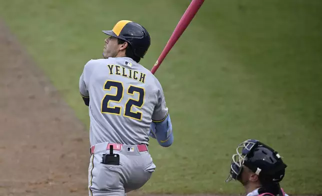 Milwaukee Brewers' Christian Yelich (22) watches his solo home run as Tampa Bay Rays catcher Danny Jansen, right, looks on during the fourth inning of a baseball game, Sunday, May 11, 2025, in Tampa, Fla. (AP Photo/Phelan M. Ebenhack)