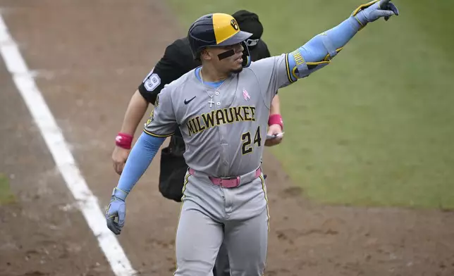 Milwaukee Brewers' William Contreras (24) points toward the stands after hitting a solo home run during the fourth inning of a baseball game against the Tampa Bay Rays, Sunday, May 11, 2025, in Tampa, Fla. (AP Photo/Phelan M. Ebenhack)