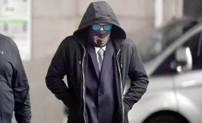 Adam Carruthers, 31, arrives to attend Newcastle Crown Court where he is accused of criminal damage after the felling of the Sycamore Gap tree - valued at £622,000 and £1,114 damage to Hadrian's Wall - in Newcastle, England, Wednesday, April 30, 2025. (PA via AP)