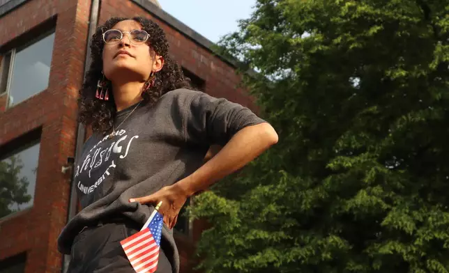 Harvard University junior Avinashi Bhandari stands on the podium before speaking at a protest against President Donald Trump's recent sanctions against Harvard in front of Science Center Plaza on Tuesday, May 27, 2025, in Cambridge, Mass. (AP Photo/Leah Willingham)
