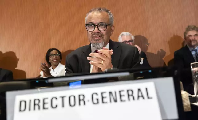 Tedros Adhanom Ghebreyesus, Director General of the World Health Organization (WHO), applauds as member countries approve an agreement to combat future pandemics, during the 78th World Health Assembly (WHA78) at the European headquarters of the United Nations in Geneva, Switzerland, Tuesday, May 20, 2025. (Magali Girardin/Keystone via AP)
