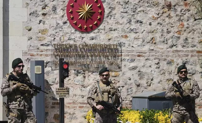 Turkish security members stand guard at Dolmabahce palace where talks between Russian and Ukrainian delegations are expected, in Istanbul, Turkey, Thursday, May 15, 2025. (AP Photo/Dilara Acikgoz)
