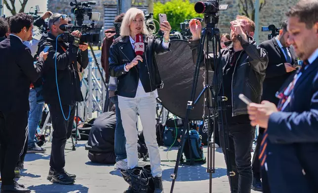 Journalists work near Dolmabahce palace where talks between Russian and Ukrainian delegations are expected, in Istanbul, Turkey, Thursday, May 15, 2025. (AP Photo/Dilara Acikgoz)