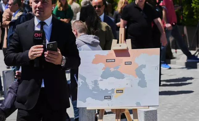 Journalists work near Dolmabahce palace where talks between Russian and Ukrainian delegations are expected, in Istanbul, Turkey, Thursday, May 15, 2025. (AP Photo/Dilara Acikgoz)