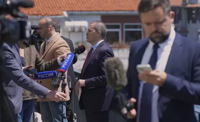 Journalists work near Dolmabahce palace where talks between Russian and Ukrainian delegations are expected, in Istanbul, Turkey, Thursday, May 15, 2025. (AP Photo/Dilara Acikgoz)