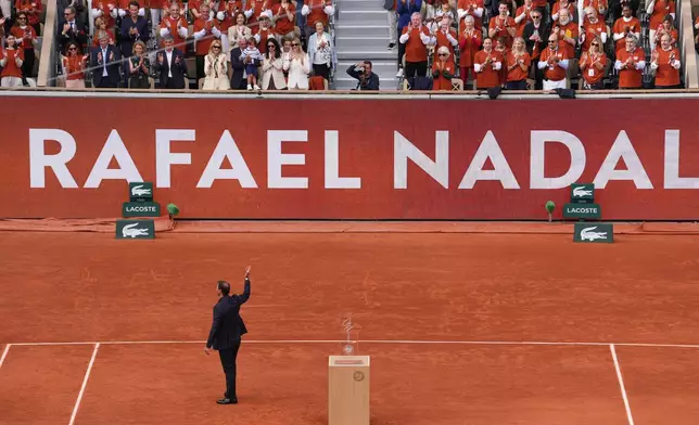 Rafa Nadal waves to the crowd during a farewell ceremony at center court Philippe-Chatrier, at the Roland-Garros stadium, in Paris, Sunday May 25, 2025 (AP Photo/Thibault Camus)