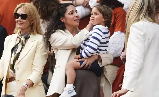 Rafa Nadal's wife, Maria Francisca Perello, holds her son Rafael Junior, during a farewell ceremony at center court Philippe-Chatrier, at the Roland-Garros stadium, in Paris, Sunday May 25, 2025. (AP Photo/Lindsey Wasson)