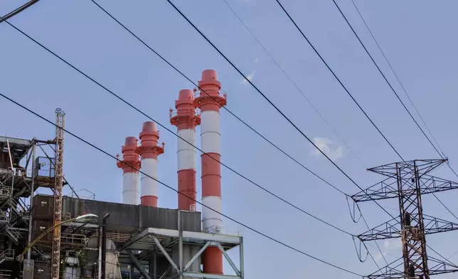 Power lines rise in front of electric towers and smokestacks at the Palo Seco power plant in Toa Baja, Puerto Rico, Thursday, May 8, 2025. (AP Photo/Alejandro Granadillo)