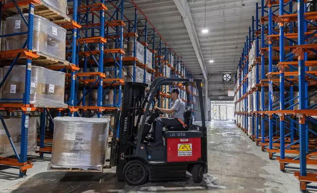 A forklift worker transports goods at a warehouse in San Juan, Puerto Rico, Thursday, May 8, 2025. (AP Photo/Alejandro Granadillo)