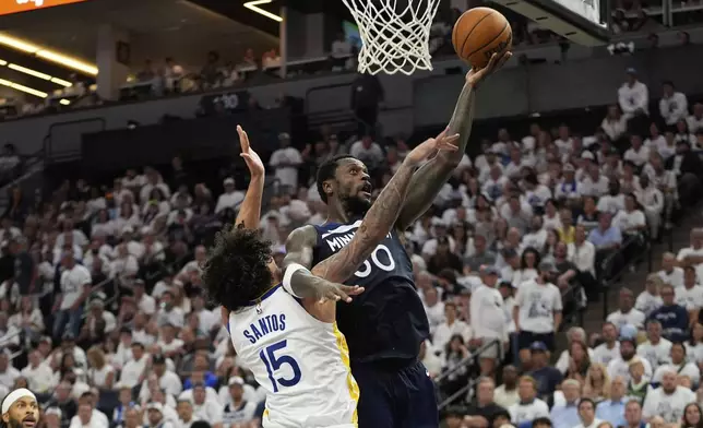 Minnesota Timberwolves forward Julius Randle (30) shoots over Golden State Warriors forward Gui Santos (15) during the second half of Game 5 of an NBA basketball second-round playoff series, Wednesday, May 14, 2025, in Minneapolis. (AP Photo/Abbie Parr)