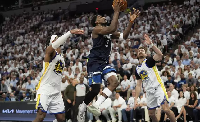 Minnesota Timberwolves guard Anthony Edwards (5) looks to shoot against Golden State Warriors' Pat Spencer, right, and Buddy Hield, left, during the second half of Game 5 of an NBA basketball second-round playoff series, Wednesday, May 14, 2025, in Minneapolis. (AP Photo/Abbie Parr)