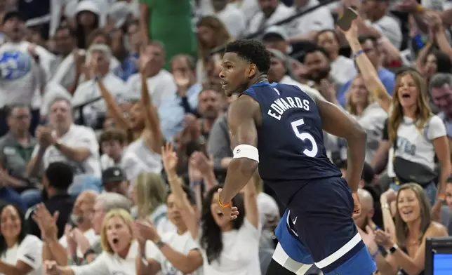 Minnesota Timberwolves guard Anthony Edwards (5) celebrates after scoring during the second half of Game 5 of an NBA basketball second-round playoff series against the Golden State Warriors, Wednesday, May 14, 2025, in Minneapolis. (AP Photo/Abbie Parr)