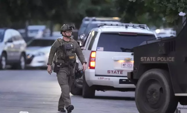 A Louisiana state police SWAT member works the scene on Iberville Street as police pursue a fugitive that escaped from a New Orleans jail, Tuesday, May 20, 2025, in New Orleans. (AP Photo/Gerald Herbert)
