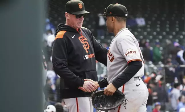 San Francisco Giants manager Bob Melvin, left, celebrates with first baseman LaMonte Wade Jr. after the Giants defeated the Chicago Cubs in a baseball game in Chicago, Wednesday, May 7, 2025. (AP Photo/Nam Y. Huh)