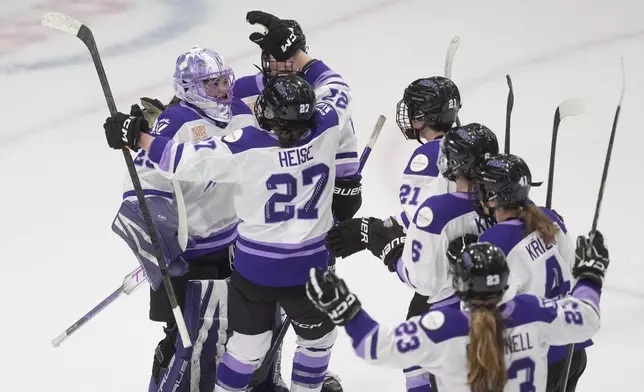 Players race to congratulate Minnesota Frost goalie Nicole Hensley (29) on her shutout as they defeat the Ottawa Charge in PWHL action, Wednesday, April 30, 2025 in Ottawa. (Adrian Wyld/The Canadian Press via AP)