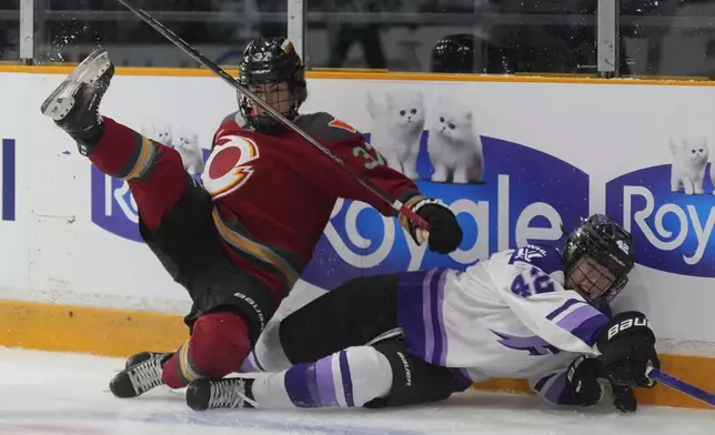 Ottawa Charge forward Rebecca Leslie (37) and Minnesota Frost defence Claire Thompson (42) collide along the boards during the first period of a PWHL game, Wednesday, April 30, 2025 in Ottawa. (Adrian Wyld/The Canadian Press via AP)