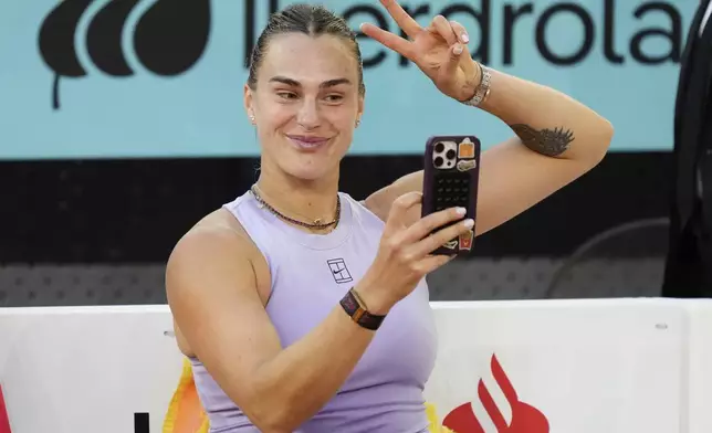 Aryna Sabalenka of Belarus makes a selfie after winning the Madrid Open tennis final against United States' Coco Gauff in Madrid, Spain, Saturday, May 3, 2025. (AP Photo/Jose Breton)