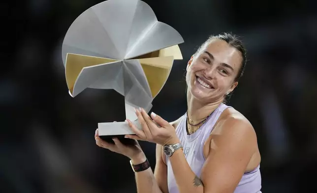 Aryna Sabalenka of Belarus holds a trophy after winning the Madrid Open tennis final in Madrid, Spain, Saturday, May 3, 2025. (AP Photo/Jose Breton)