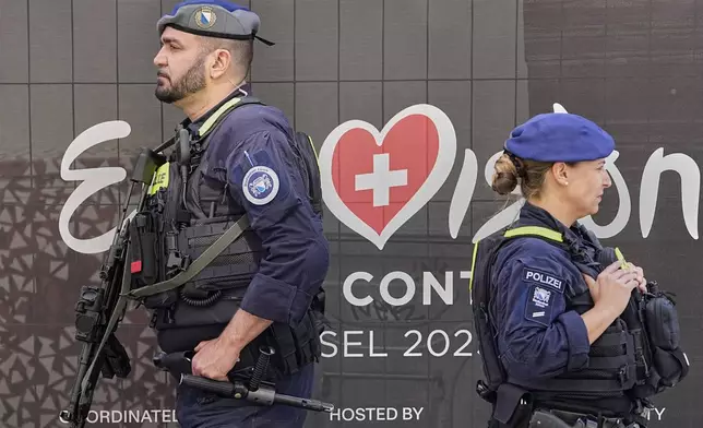 Police with machine guns secures a Eurovision square in the city center during the 69th Eurovision Song Contest week in Basel, Switzerland, Friday May 16, 2025. (AP Photo/Martin Meissner)