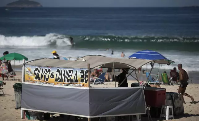 A food vendor operates a stand that also rents chairs and umbrellas on Ipanema Beach in Rio de Janeiro, Sunday, May 25, 2025. (AP Photo/Bruna Prado)