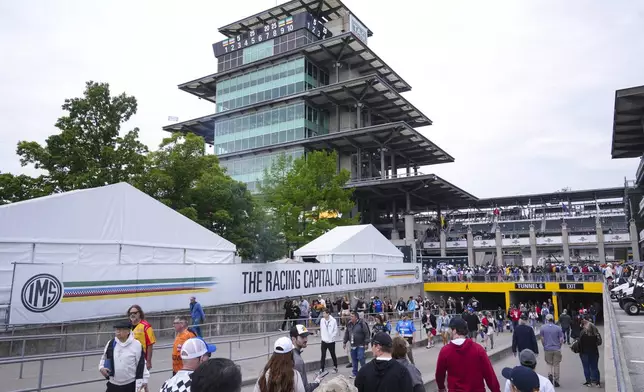 Fans make their way into the track before the start of the Indianapolis 500 auto race at Indianapolis Motor Speedway in Indianapolis, Sunday, May 25, 2025. (AP Photo/Michael Conroy)