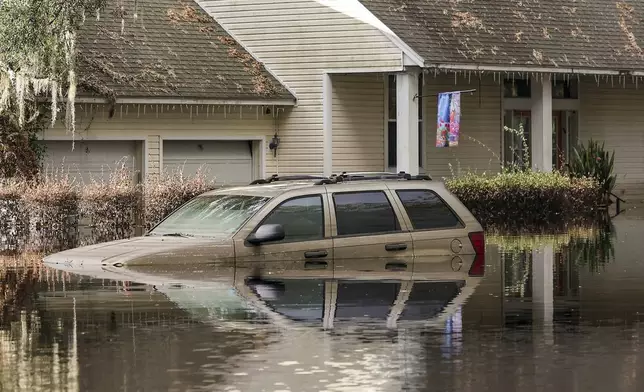 FILE - A neighborhood still flooded from Hurricane Milton prepares to have the FEMA Disaster Recover Center covert to a polling location for the general election on Monday, Nov. 4, 2024, in Ridge Manor, Fla. (AP Photo/Mike Carlson, File)