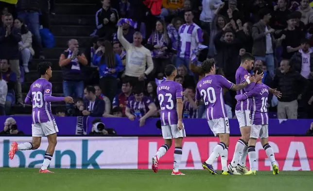 Valladolid's Ivan Sanchez, right, celebrates with teammates after scoring the opening goal during the Spanish La Liga soccer match between Valladolid and FC Barcelona at the Jose Zorrilla stadium in Valladolid, Spain, Saturday, May 3, 2025. (AP Photo/Manu Fernandez)