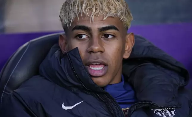 Barcelona's Lamine Yamal sits on a bench before the Spanish La Liga soccer match between Valladolid and FC Barcelona at the Jose Zorrilla stadium in Valladolid, Spain, Saturday, May 3, 2025. (AP Photo/Manu Fernandez)