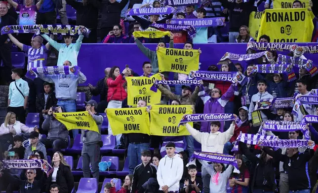 Valladolid's fans hold banners read "Ronaldo go home" during the Spanish La Liga soccer match between Valladolid and FC Barcelona at the Jose Zorrilla stadium in Valladolid, Spain, Saturday, May 3, 2025. (AP Photo/Manu Fernandez)