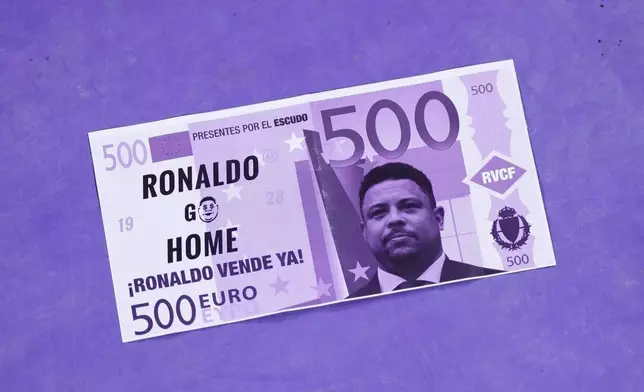 A poster with a portrait of Real Valladolid owner Ronaldo lays on a floor at the Jose Zorrilla stadium during the Spanish La Liga soccer match between Valladolid and FC Barcelona in Valladolid, Spain, Saturday, May 3, 2025. (AP Photo/Manu Fernandez)