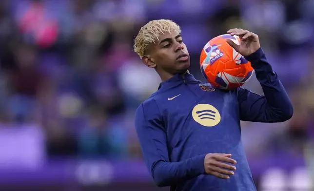 Barcelona's Lamine Yamal warms up before the Spanish La Liga soccer match between Valladolid and FC Barcelona at the Jose Zorrilla stadium in Valladolid, Spain, Saturday, May 3, 2025. (AP Photo/Manu Fernandez)