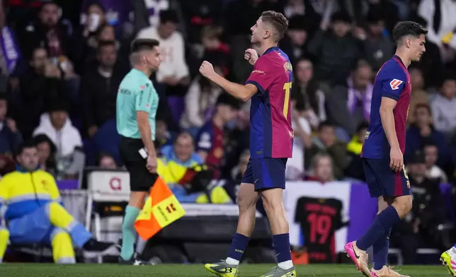 Barcelona's Fermin Lopez, centre, celebrates after scoring his side's second goal during the Spanish La Liga soccer match between Valladolid and FC Barcelona at the Jose Zorrilla stadium in Valladolid, Spain, Saturday, May 3, 2025. (AP Photo/Manu Fernandez)