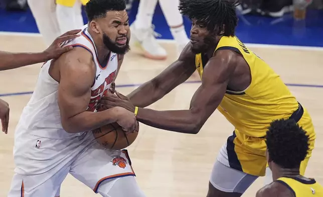 Indiana Pacers forward Jarace Walker (5) strips the ball from New York Knicks center Karl-Anthony Towns (32) during the fourth quarter of Game 5 of the NBA basketball Eastern Conference final, Thursday, May 29, 2025, in New York. (AP Photo/Frank Franklin II)