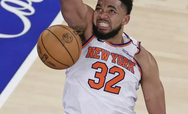 New York Knicks center Karl-Anthony Towns (32) scores against the Indiana Pacers during the fourth quarter of Game 5 of the NBA basketball Eastern Conference final, Thursday, May 29, 2025, in New York. (AP Photo/Adam Hunger)