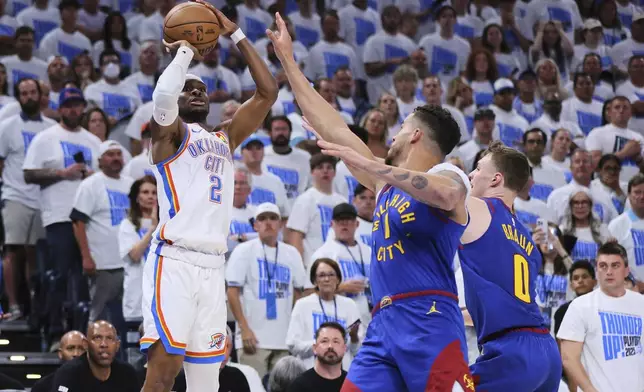 Oklahoma City Thunder's Shai Gilgeous-Alexander (2) shoots over Denver Nuggets' Michael Porter Jr. (1) and Christian Braun (0) in the second half of Game 5 of an NBA basketball second-round playoff series Tuesday, May 13, 2025, in Oklahoma City. (AP Photo/Nate Billings)