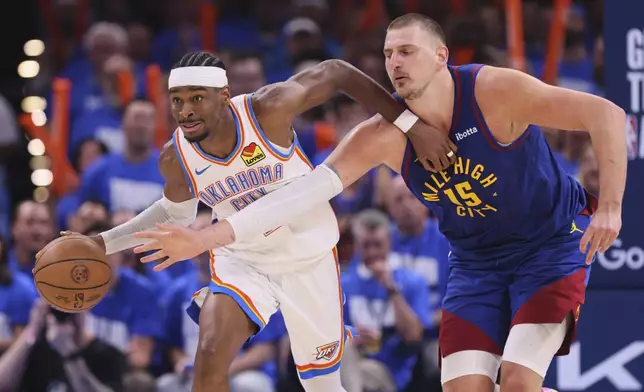 Oklahoma City Thunder's Shai Gilgeous-Alexander, left, advances the ball upcourt under pressure from Denver Nuggets center Nikola Jokic (15) in the second half of Game 5 of an NBA basketball second-round playoff series Tuesday, May 13, 2025, in Oklahoma City. (AP Photo/Nate Billings)