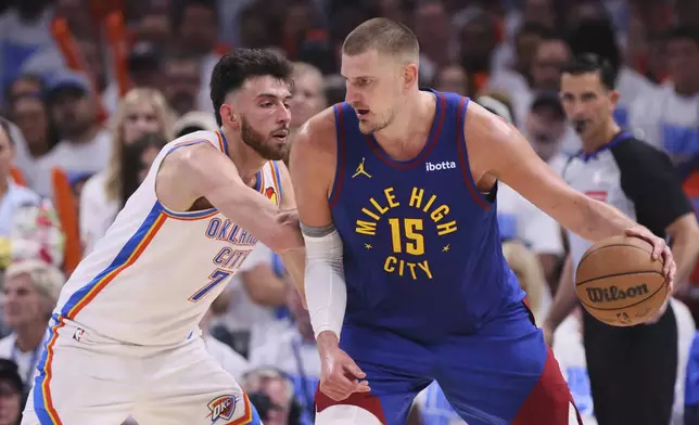 Denver Nuggets' Nikola Jokic (15) works to the basket against Oklahoma City Thunder's Chet Holmgren, left, in the second half of Game 5 of an NBA basketball second-round playoff series Tuesday, May 13, 2025, in Oklahoma City. (AP Photo/Nate Billings)