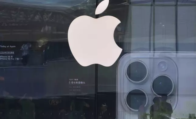 People visit an Apple store promoting its iPhone 16 at an outdoor shopping mall in Beijing, Sunday, May 11, 2025. (AP Photo/Andy Wong)