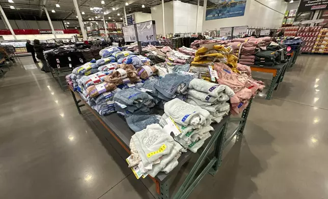 FILE - Children's clothing sits stacked on a table for shoppers in a Costco warehouse Thursday, Jan. 23, 2025, in Sheridan, Colo. (AP Photo/David Zalubowski, File)