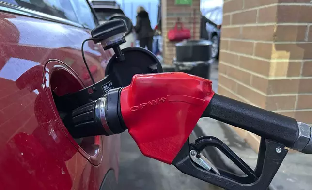 FILE - A motorist fills up the tank of a vehicle at a Costco gasoline station late Sunday, Feb. 16, 2025, in Sheridan, Colo. (AP Photo/David Zalubowski, File)