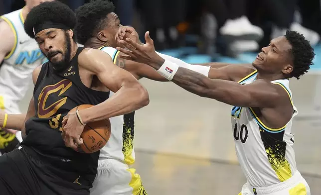 Cleveland Cavaliers center Jarrett Allen (31) takes the ball from Indiana Pacers center Thomas Bryant, second from left, and guard Bennedict Mathurin (00) during the second half of Game 3 in the Eastern Conference semifinals of the NBA basketball playoffs in Indianapolis, Friday, May 9, 2025. (AP Photo/Michael Conroy)