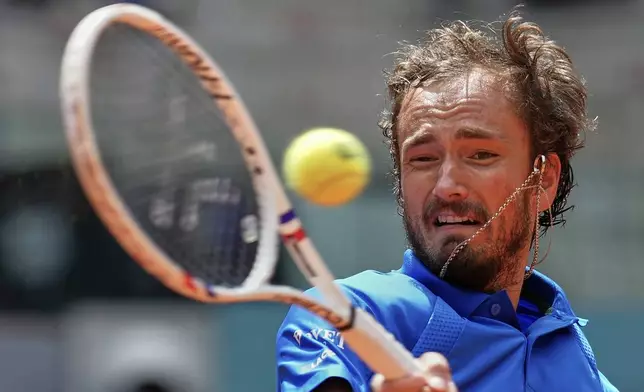 Russia's Daniil Medvedev returns the ball against Casper Ruud of Norway during the Madrid Open tennis tournament in Madrid, Spain, Thursday, May 1, 2025. (AP Photo/Manu Fernandez)